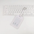 White PU leather luggage tag with clear ID window and white strap on desk - Stitched Frame No-Flip Style / White