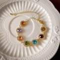 Golden butterfly flower jewelry set with colorful round gemstones on a white ceramic plate - 64# Colorful Round Gemstone Bracelet