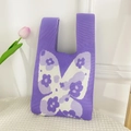 Purple knitted tote bag with butterfly pattern and floral details in a fresh setting - Butterfly Purple