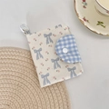 Detail of floral canvas card holder with blue gingham flap and white resin snap button - Blue Bowknot