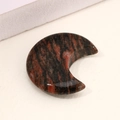 Crescent moon-shaped natural stone ornament featuring red and black striped agate texture - Red Sesame Stone