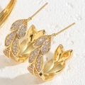 Macro shot of gold leaf earrings featuring zircon pave and intricate metallic textures - Leaf Zirconia Style (ES2276)