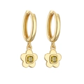 Detailed macro view of gold-plated horseshoe hoop earrings with yellow zircon flower charms - Gold Olive Green Zirconia Flower