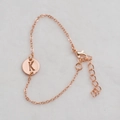 Elegant rose gold chain bracelet with a hollow round pendant featuring engraved letter K - Rose Gold K