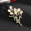 Detail of deer brooch with cat eye stone antlers and rhinestones on black background - Cat's Eye Deer