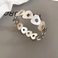 Detail of silver hollow heart bracelet featuring fine floral and leaf engravings on metal - Continuous Heart Hollow Style (Silver)