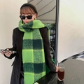 Thick green and black checkered mohair scarf with braided fringe worn by model outdoors - Green Rainbow