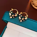 Detailed view of heart-shaped gold earrings with leopard print enamel on jewelry box - 7# Leopard Heart Drip Oil Hoop Earrings