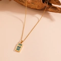 Gold stainless steel tarot necklace featuring sun and rainbow pendant on wooden prop - The Sun (C218)