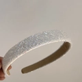 Detailed view of a white shimmering headband with sparkling sequins and beige lining - White