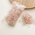 Macro detail of colorful pastel elastic hair bands for girls in packaging and loose pile - Light Pink Series (1000Pcs)