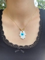 Model wearing a gold Hamsa hand and Evil Eye necklace on the collarbone for scale - Hamsa Hand Pendant Necklace / Gold+White