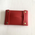Detail of red lychee grain leather mini organizer pouch with brass snap buttons - Red