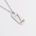Macro detail of silver titanium steel rectangular pendant with number 7 and Lucky engraving - Number 7
