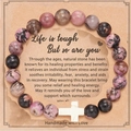 Pink zebra stone bead bracelet with a white cross pendant on a vintage gift card - Red Line Blue Pattern Cross With Card Style
