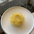 Detail of vibrant yellow pleated organza hair scrunchie on a white ceramic plate - Mesh Scrunchie / Goose Yellow