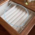 Elegant blue beaded necklace featuring a silver bow pendant on a jewelry display box - Blue-Bowknot Pendant