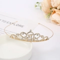 Detail of elegant gold crystal bridal tiara with rhinestones on a decorative tray - Crown 6