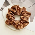 Brown satin scrunchie with silk-like texture on minimalist white background - Brown