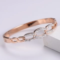 Detailed view of rose gold geometric bracelet featuring pave-set sparkling crystals - Rose Gold
