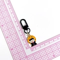 Cartoon vampire keychain with black cloak and orange moon on a pink scale cutting mat - Devil (Black Clasp)