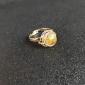 Detailed macro view of gold wire-wrapped ring with natural crystal stone inclusions - Adjustable Open / Peach Stone