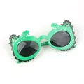 Close-up of green crocodile pirate kids sunglasses with skull hat and gray lenses - Green