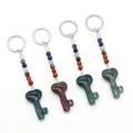 Seven chakra natural stone keychain set with heart-shaped key pendant on white background - India Agate