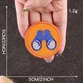 Round orange scout badge with blue binoculars embroidery and stitched edges, 5cm diameter - Orange Binoculars