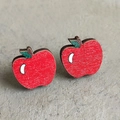 Close-up of red wooden apple earrings on a rustic grey wood grain background - Apple Shaped