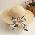 Detail of wide brim straw hat featuring elegant floral ribbon and pearl bead decoration - Beige