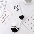 White crew socks featuring black cartoon bear patterns and Luck text in checkerboard style - Black White Bear (No.01 Bear & LUCK)