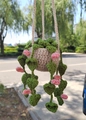 Detailed view of a handmade crochet potted plant pendant with green leaves and pink flowers - No.5 (Beige Pot Heart Leaves Pink Flower)