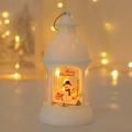 Detail of white Christmas lantern showing a glowing snowman scene and Merry Christmas text - Snowman