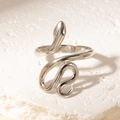 Minimalist silver snake-shaped open ring in titanium steel on white stone surface - Steel Color Style 2