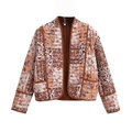 Detail of bohemian quilted jacket showing floral print and brown woven trim contrast - S / Tan