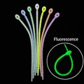 Macro detail of colorful silicone zip ties showing anti-slip teeth and luminous glow effect - Luminous Mixed Colors