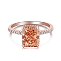 Rose gold ring with radiant cut orange gemstone and side diamonds on a white background - US 7 / Orange-Rose Gold Setting