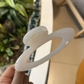 Elegant cream white hollow oval hair claw clip for women shown in a natural setting - Jelly White