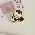 Detail showing hand embroidered white cat patch with a red donut and yellow border - Cat with Doughnut