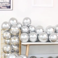 Metallic silver chrome latex balloon set displayed in a stylish gold wire storage basket - Metallic Silver - Small