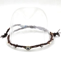 Close-up of brown braided PU leather hat band with evil eye charm and metal beads - 33 Brown Evil Eye