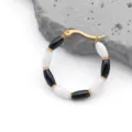 Detailed view of bamboo style gold hoop earrings with black and white enamel beads - Bamboo Joint Style (T1280) / 1 Piece (31x31mm) / Black and White