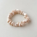 Elegant champagne satin scrunchie with a glossy silk-like finish for women's hair - Nude