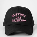 Close-up of pink SUPPORT DAY DRINKING embroidery on black cotton baseball cap - One Size / Black