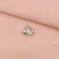 Macro shot of a silver whale fish pendant showing detailed textures on a pink fabric - Fish (5#)