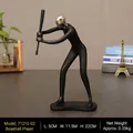 Statue de joueur de baseball noir mat avec tête argentée sur table grise - Joueur de Baseball - Tête Argentée