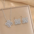 Elegant silver floral jewelry set with pavé cubic zirconia on a champagne silk background - Silver Set (557)