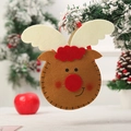 Sac cadeau de Noël en feutre renne marron fait main suspendu à une branche de pin enneigée - Renne à Fond Rond