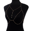 Detailed close-up of a gold body chain with rhinestone pendants and delicate beads on a mannequin - Body Chain / Gold